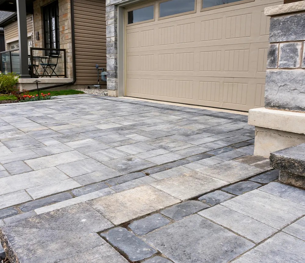 Pavers on a driveway that connect to a small patio and front door