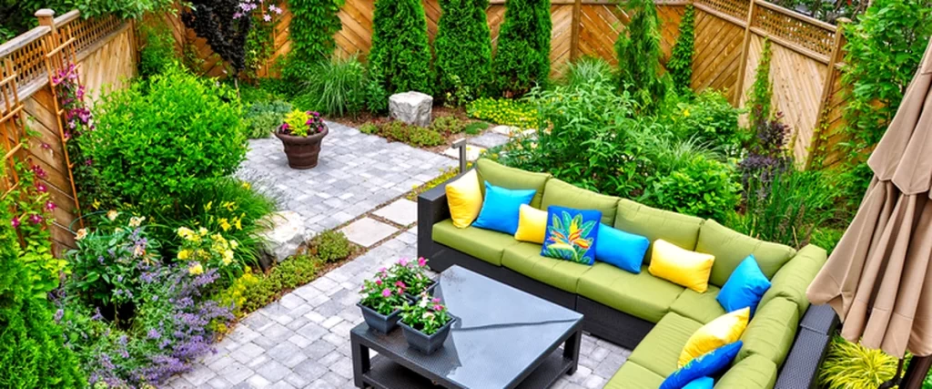 vibrant paver patio with green sectional colorful cushions lush garden landscaping
